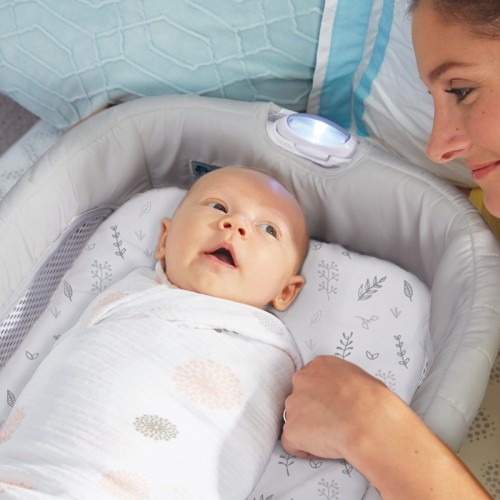 A baby lying in THE FIRST YEARS Close & Secure Sleeper